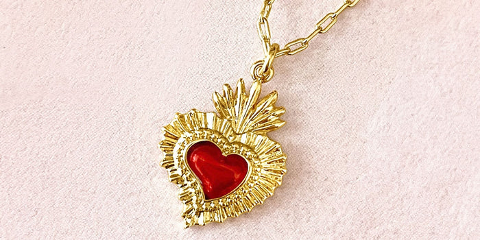Fortune & Frame Sacred Heart Pendant on a pink background.